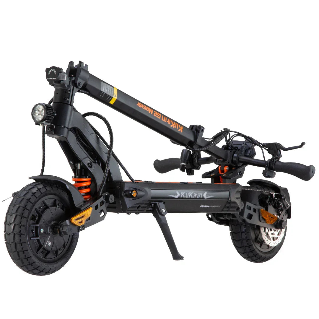 Black electric scooter with orange accents, fat tires, and front headlight, folded for storage