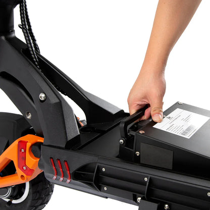 Hand removing battery from black and orange electric scooter with red taillights