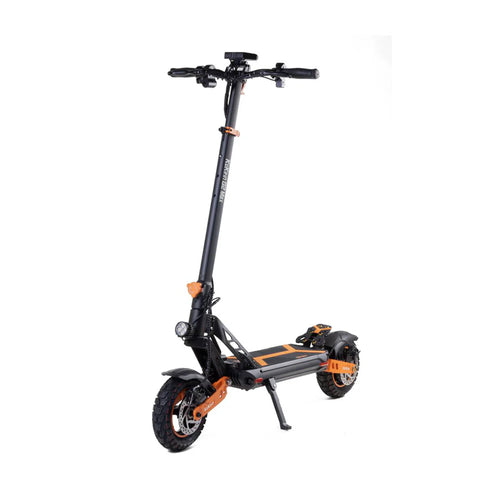 Black and orange electric scooter with thick tires and front light, standing on kickstand
