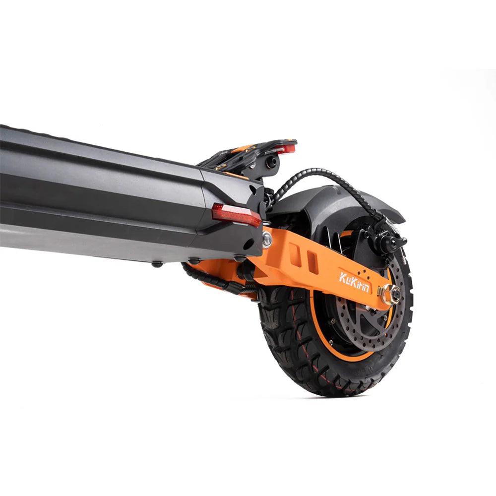 Orange and black electric scooter rear wheel with disc brake and rugged tire, KuKihin branding visible